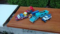 All five toy trucks arranged on tabletop