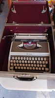 Grey and white Royal 300 portable typewriter inside hard carrying case
