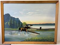 Full view of framed oil painting showing moose in lake scene