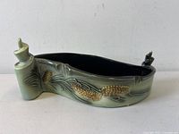 Side view of Hull planter showing pinecone relief and glaze