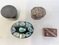 Top view of four paua shell pill boxes (round, octagon, rectangle, oval)