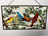 front view of entire stained glass panel showing bird design and chain