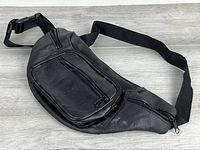 Front view showing three zippered compartments and strap