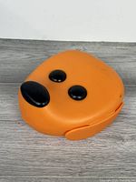 Top view showing dog face lid with black nose and eyes