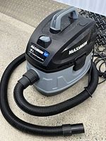 Full view of Maximum wet/dry vacuum with hose and nozzle