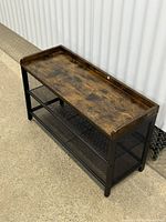 Full view of bench showing wood-look top and metal frame