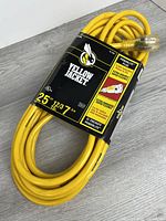 Coiled Yellow Jacket extension cord with packaging showing brand, length and gauge