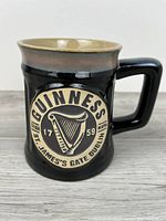 Front view showing Guinness harp medallion and overall mug shape