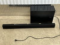 Soundbar and subwoofer with power cord