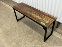 bench perspective view showing metal frame and wood-look seat