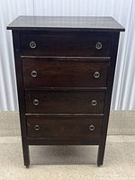 Front view of dresser showing four drawers and ring pulls