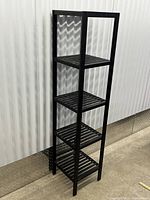Front view of tall black metal shelving unit