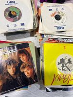 Stacks of 7-inch singles in sleeves, visible Honeymoon Suite sleeve