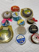 All 12 assorted fishing line spools laid out