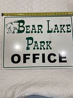 Full view of sign with tape measure showing size