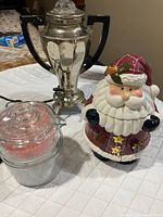 Overall view of Santa cookie jar, coffee urn, glass jar