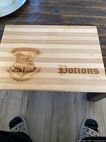 Full view of striped bamboo cutting board showing crest and text