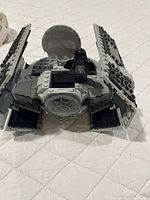 Front view of assembled TIE Advanced spacecraft with wings open and Darth Vader minifigure seated