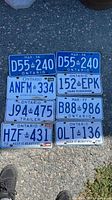 Eight licence plates laid out on pavement