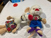 Both plush toys lying on quilted surface