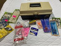 Plano tackle box surrounded by packaged tackle items