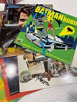Stack of six LPs showing Batman & Robin cover on top, others partially visible