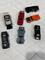 all seven cars laid out on quilt
