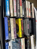 Overview of cassette tapes in zippered carrying case showing multiple identifiable spines
