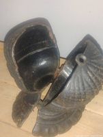 Object opened to show hollow interior and hinge