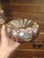 Top view showing glazed surface, central well, side opening