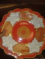 Front view of porcelain plate showing color, pattern and scalloped rim