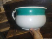 Side view showing teal band and overall shape