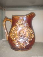 Front view showing relief cameo and scrollwork