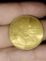 Obverse with car, planet ring, starburst, division names, date 1954