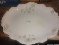 Top view of platter showing green floral design and scalloped rim