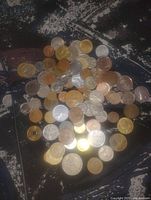 Top view of entire pile showing variety of coin sizes and metals