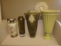 All four vases side by side on shelf