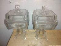 pair of square pedestal crystal jars with lids front view