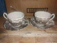 Two matching cups on saucers, front view