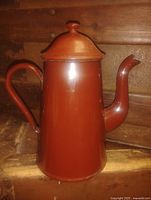 Full view of enamel coffee pot showing lid, spout and handle