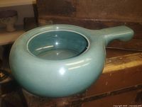 Top angle view of glazed ceramic pot showing color, shape and handle