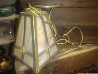 Overall view of brass and slag glass ceiling light with chain