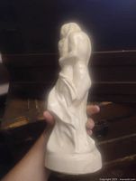 Full view of sculpture held upright, shows overall form and color