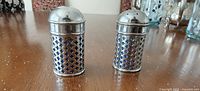 Front view of pair of shakers on table