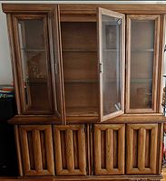 Front view showing full buffet and hutch, doors open revealing shelves