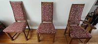 Three maple dining chairs—two side, one arm—showing upholstery and wood finish