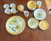 Full set overview showing plates, bowls, cups, sugar, creamer