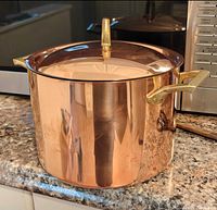Full view of copper stock pot with lid on countertop