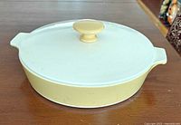 Casserole with lid closed, showing pastel yellow body and lid knob
