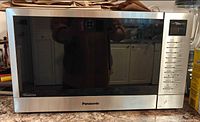 Front view of Panasonic Genius microwave showing door and overall condition